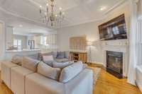 Living room with gas fireplace and coffered ceiling