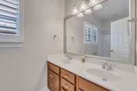 Upstairs bathroom has dual vanities, convenient access to additonal bedrooms