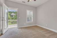 3rd bedroom with ceiling fan and porch access