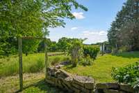 garden fence leading to chicken coop and open pasture