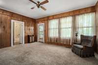 den with hardwood flooring under carpet