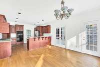 A view toward the kitchen from the breakfast room.  Note the glass pocket doors to the family room.