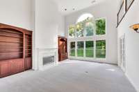 What a fabulous family room!  Soaring ceiling and a wall of windows.