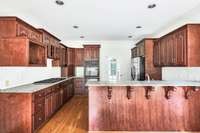 Kitchen features granite counters and custom tile backsplash.