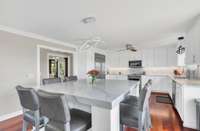 The kitchen has a huge center island/eating area with quartz counter.