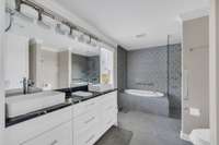 The primary bath is huge with a separate tub, shower, and custom vanities.