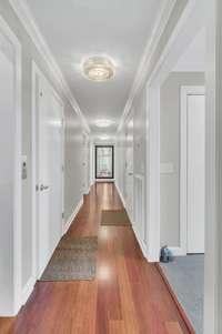 The hallway has custom lighting and those stunning floors.