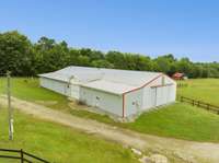 Horse barn with 2 wash bays, tack room, mechanical storage and trainer's quarters with bath