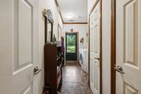 Utility Room from living room.  Washer and dryer to remain.  Exit to covered Porch.