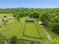 Carport to remain, square training ring, RV site with power, water, and septic.  Storm Shelter. Circular training ring