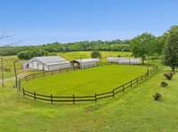 Circular Training ring and 5 bay garage.  Equipment carport to remain.  One of the 50' trailers to remain for hay storage.