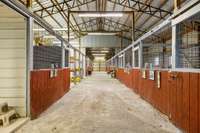 Horse barn with 2 wash bays, tack room, mechanical storage and trainer's quarters with bath