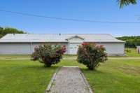 Horse barn with 2 wash bays, tack room, mechanical storage and trainer's quarters with bath