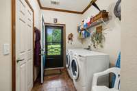 Utility Room.  Washer and dryer to remain.  Exit to covered Porch.