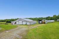 5 bay garage with work shop, paint room, and 2 other finished spaces.  All heated and cooled.  Equipment carport to remain.  One of the 50' trailers to remain for hay storage.