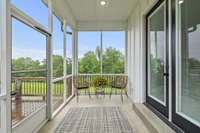 Screened-in porch off the dining room and the primary bedroom. The open wood deck is just beyond this covered porch.