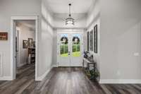 Front entry double doors. The room to the left is the home office.