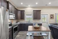 The kitchen has granite countertops and stainless steel appliances.