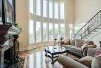 LIVING ROOM SPACE WITH GRAND WINDOWS, SHOWING OFF THE STUNNING VIEWS