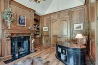 ANOTHER VIEW OF STUDY/OFFICE SPACE WITH FIREPLACE AND BOOKCASES