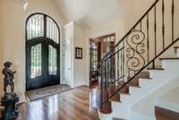 FRONT ENTRY OF HOME, ROARING CEILINGS, ALL BRAZILIAN HARDWOODS, AND TRAVERTINE TILE, WITH CUSTOM MILLWORK.