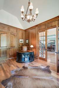 BEAUTIFUL MILLWORK OFFICE/STUDY WITH BOOKSHELVES AND FIREPLACE.