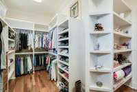 WALK IN PRIMARY CLOSET ON MAIN LEVEL WITH CUSTOM WOOD SHELVING