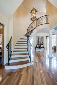 GRAND STAIRCASE WITH WROUGHT IRON HANDRAILS