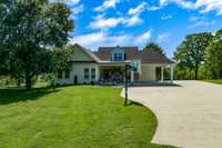 Back of home with added concrete parking and basketball goal.