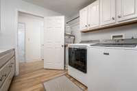 Laundry room is near bedrooms and connected to master suite.