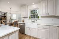 Updated kitchen with marble countertops, painted cabinets, updated hardware, updated appliances, double under mounted farm sink, and walk in pantry.