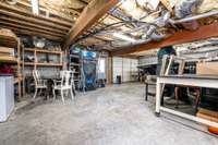 Unfinished basement with 2 garage doors. Interior storage room and plastic covered crawl space.