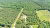 Aerial view shows the woods and privacy of this home