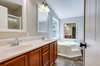 Double vanities and soaking tub in primary bathroom