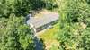 Aerial view of home shows the privacy and surrounding woods