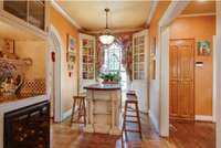 Butler's Pantry has built in cabinetry with wine cooler.