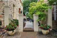 This is the gate to your enclosed, private brick front patio.