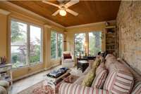 Sunroom with bool shelves, tile floor and bead board ceiling