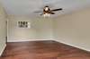 Living room with a large lighted ceiling fan.