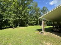 View of the backyard. There are trails that lead to the creek with a waterfall.