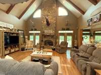 Beautiful, vaulted ceiling with wood beams and a massive stone fireplace with insert.