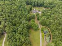 Aerial view showing home and pond.