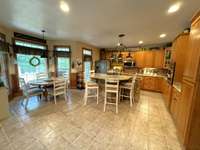 Kitchen has eat-in dinette to the side overlooking the backyard.