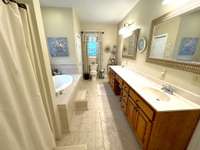 Primary Bath has double vanities and whirlpool tub.