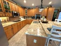 Kitchen has granite countertops, SS Appliances and tile floors.