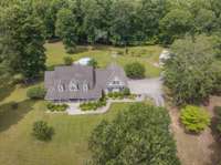 House sits in the middle of 16.94 acres for lots of privacy.