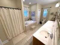 Primary Bath has separate shower and tiled floors.