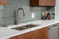 The owner chose modern materials & design elements that would seamlessly mesh with the preserved vintage elements of this home, like this beautiful white quartz countertops, soft teal tile that fits the MCM hues, & contemporary fixtures