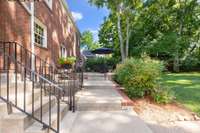 The view across the back patio with stairs leading up to the kitchen and down to the basement.