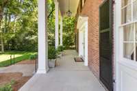 The front covered porch can hold several pieces of outdoor furniture for enjoying the front yard.